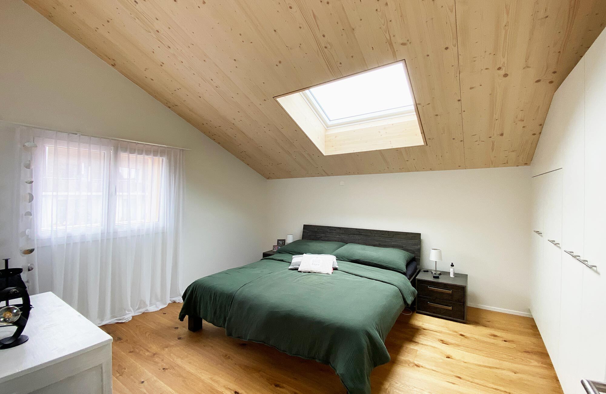 Schlafzimmer mit Holztäfer und Dachfenster
